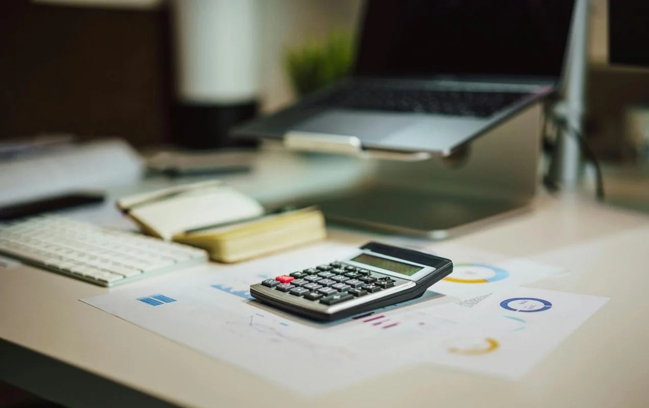 desk with charts and a calculator